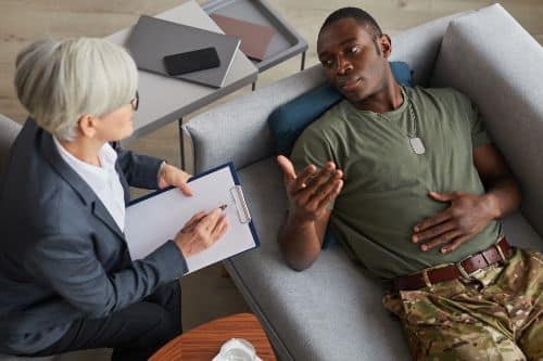 High angle view of depressed soldier and his psychotherapist during a session