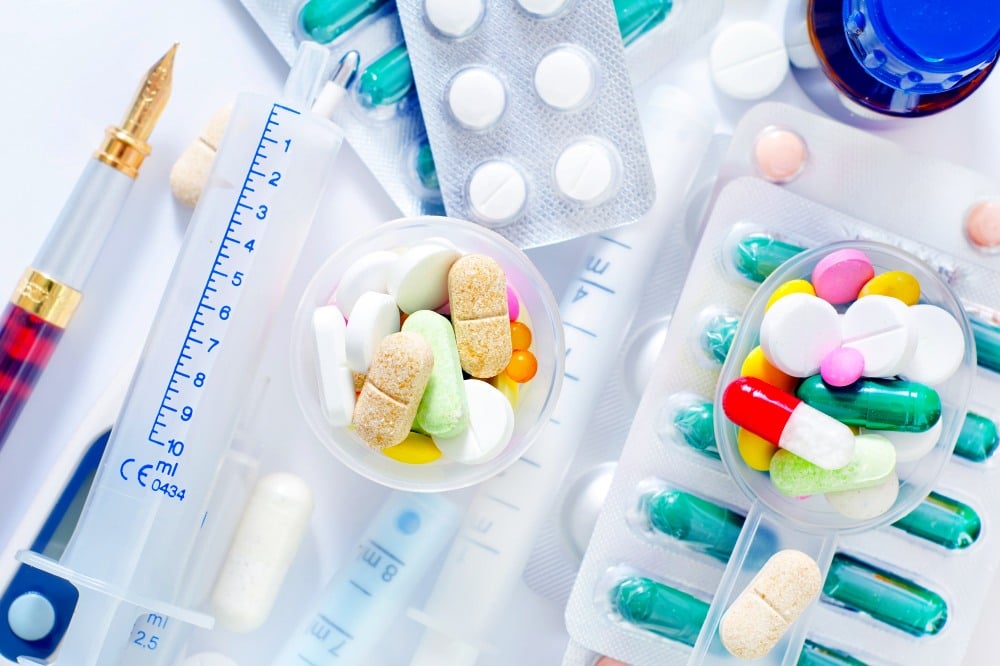 various pills and prescription medication on a white background